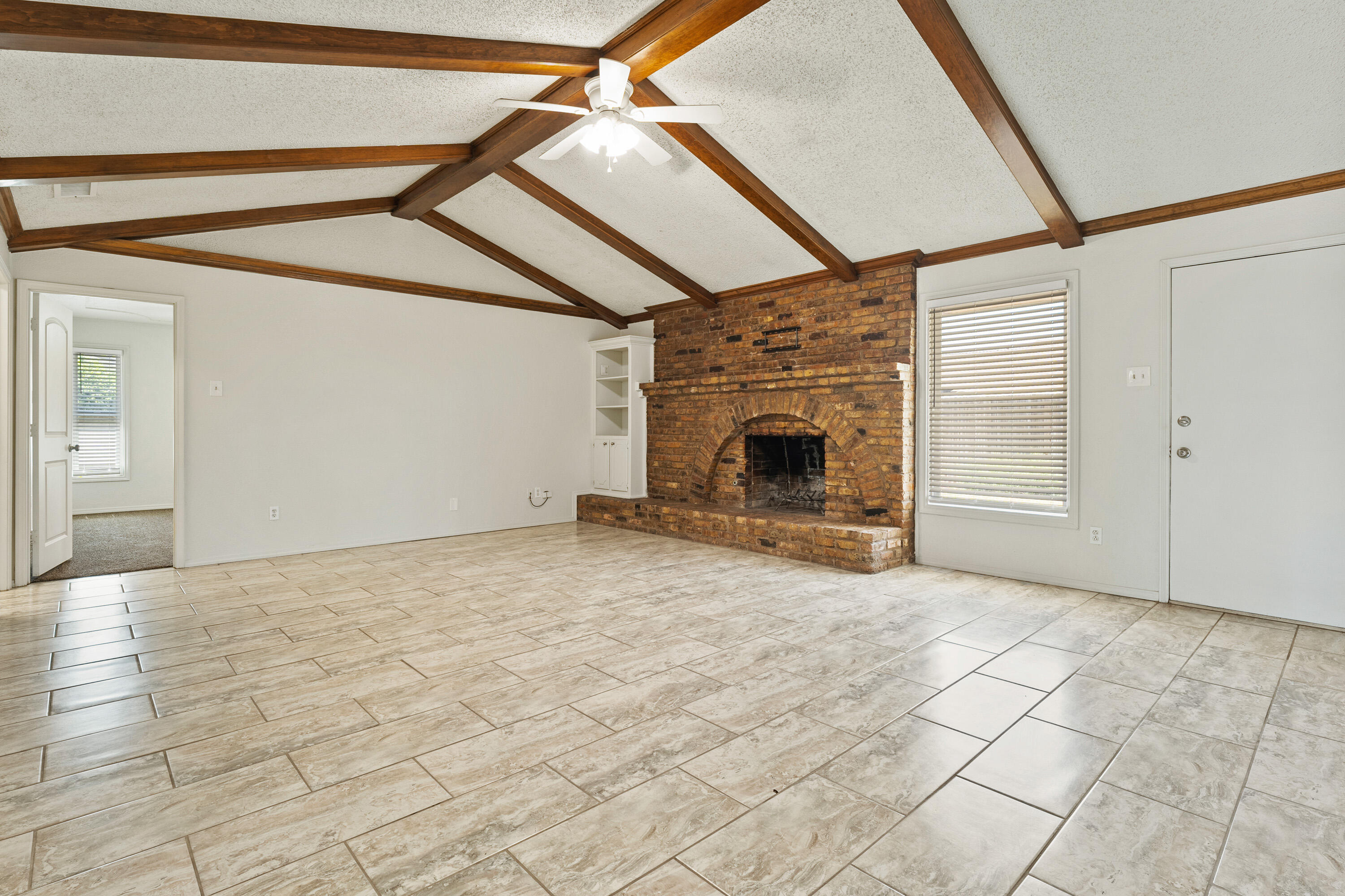 7004 Wayne Avenue Lubbock, TX 79424 - Photo 6 of 29 a view of empty room with dishwasher and fireplace