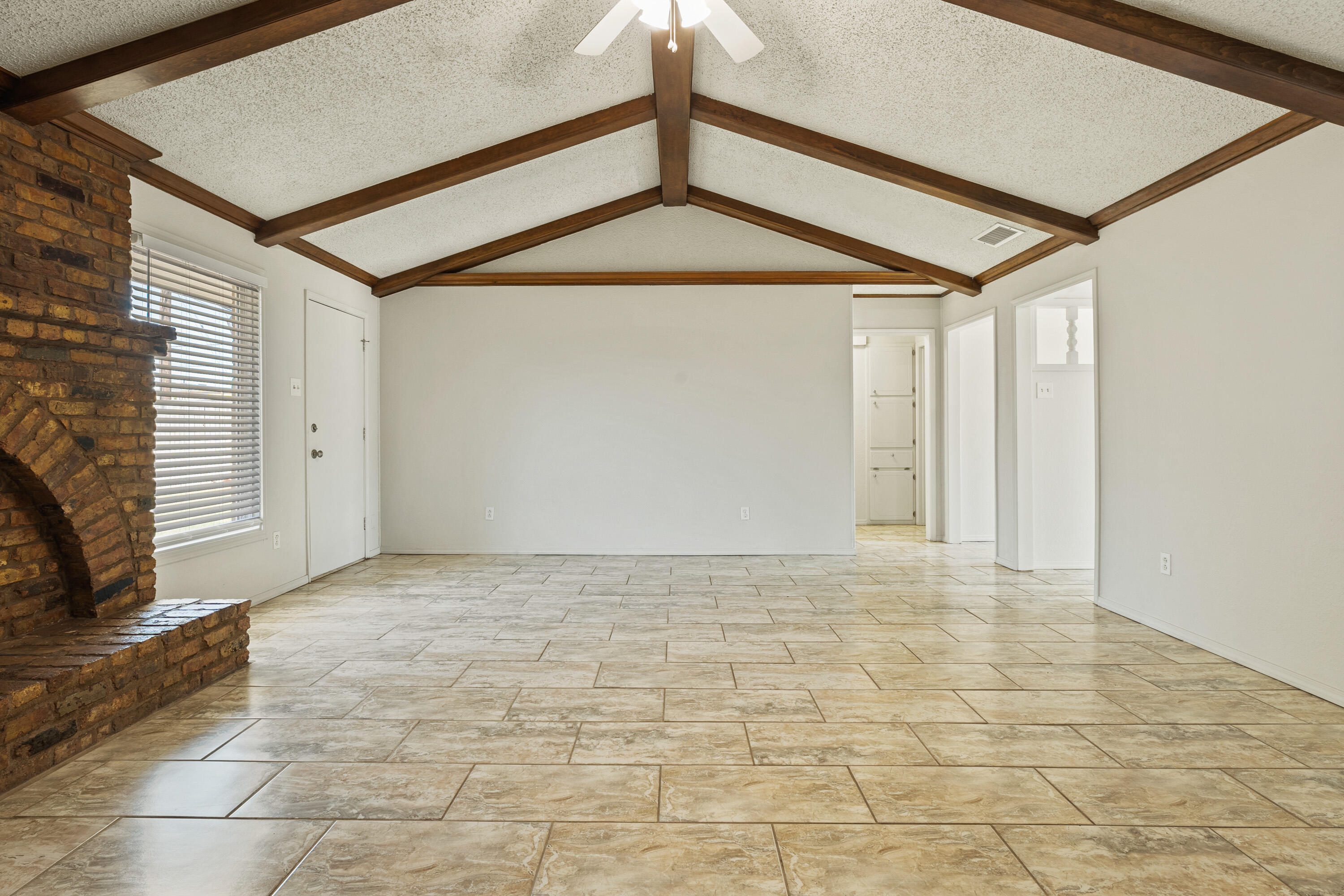 7004 Wayne Avenue Lubbock, TX 79424 - Photo 10 of 29 a view of an empty room with a fireplace and a window