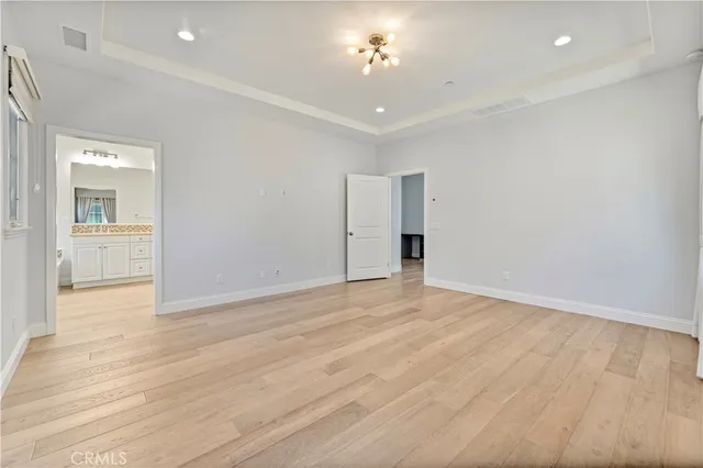 a spacious bathroom with a granite countertop sink mirror and bathtub