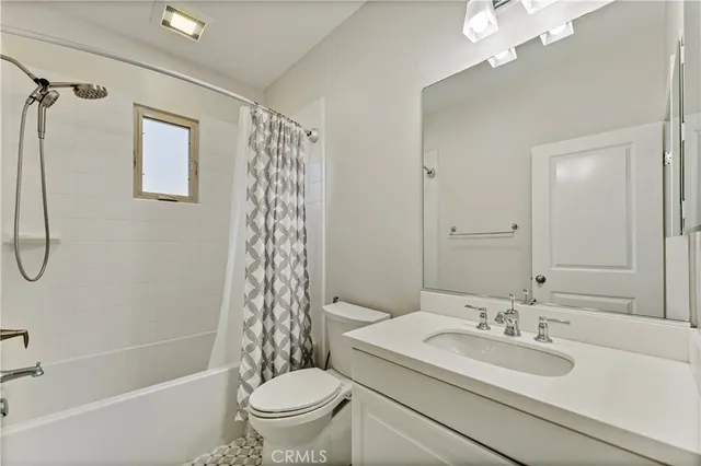 an empty room with a window and a ceiling fan