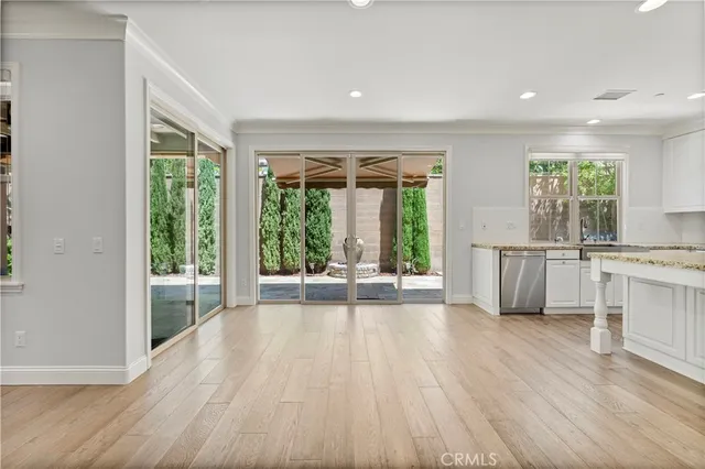 a kitchen with granite countertop a stove a sink and a refrigerator