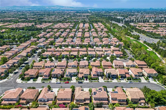 an aerial view of a residential houses with outdoor space and street view