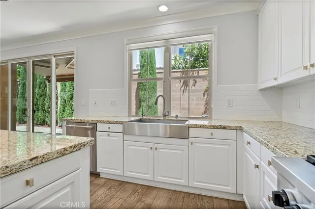 a kitchen with stainless steel appliances granite countertop a refrigerator and a sink