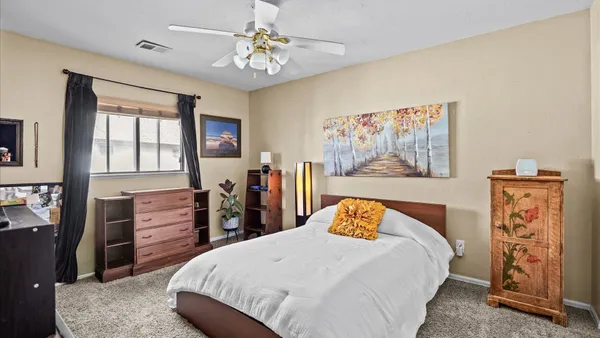 a bedroom with a bed and a dresser