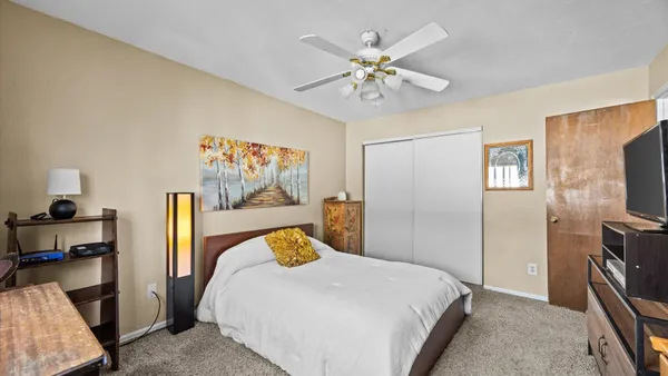 a bedroom with a bed and a flat screen tv