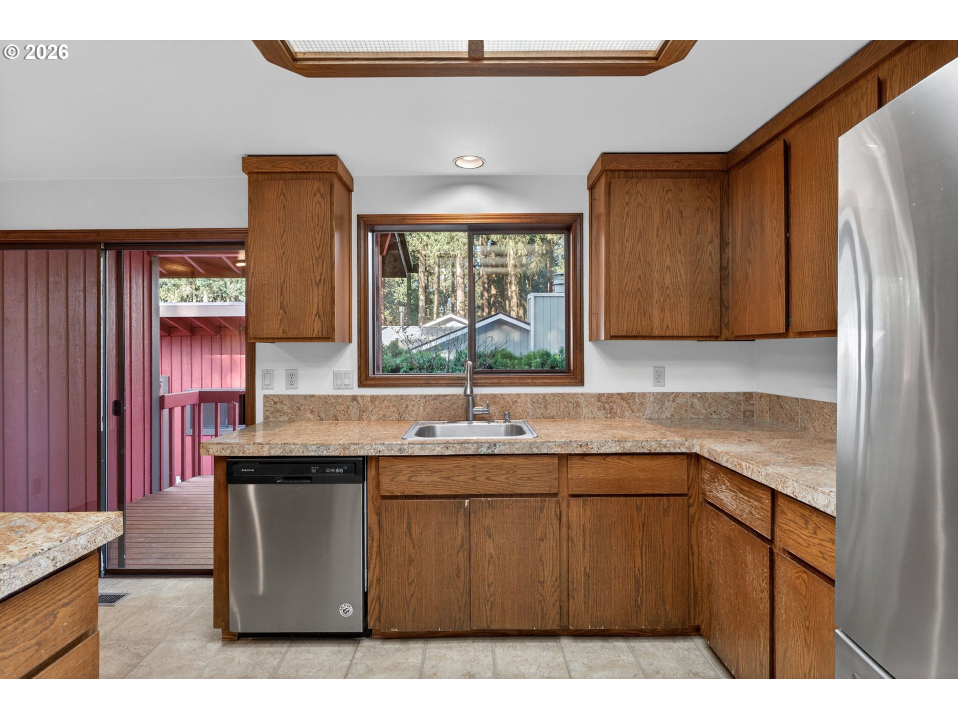 5205 Southwest 153rd Avenue Beaverton, OR 97007 - Photo 12 of 47 a kitchen with a sink cabinets appliances and a window