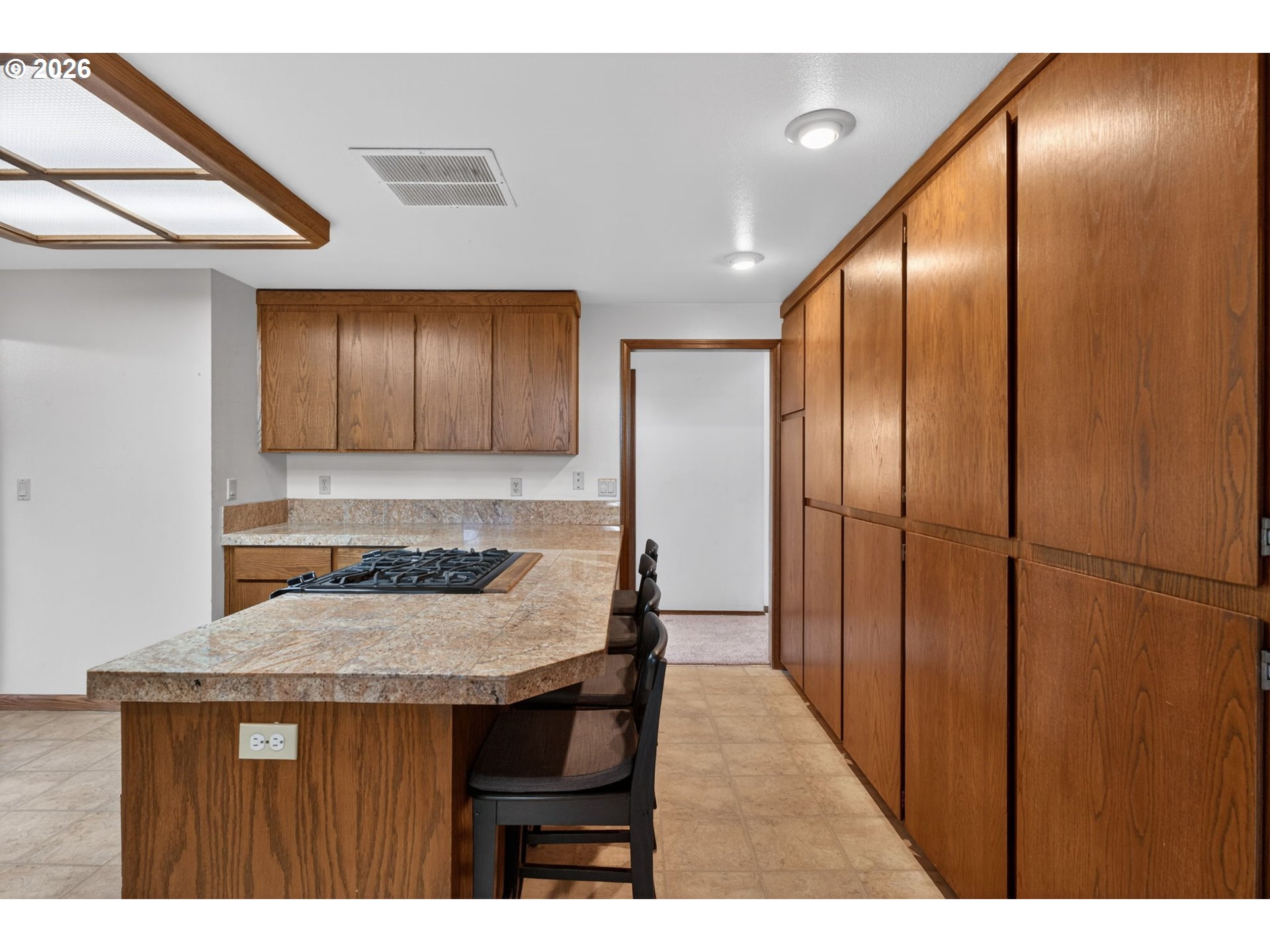 5205 Southwest 153rd Avenue Beaverton, OR 97007 - Photo 13 of 47 a kitchen with granite countertop a wooden floor and refrigerator