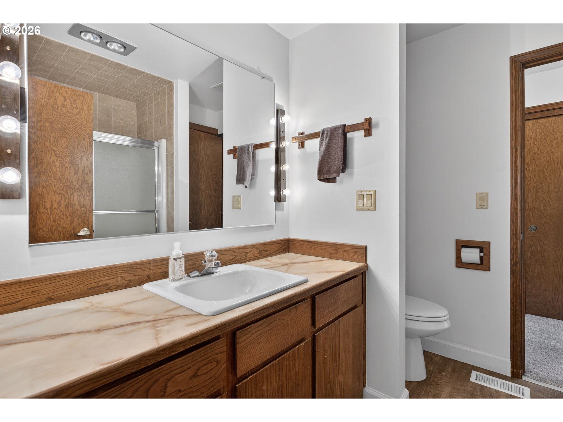 5205 Southwest 153rd Avenue Beaverton, OR 97007 - Photo 18 of 47 a bathroom with a granite countertop sink a toilet and a mirror