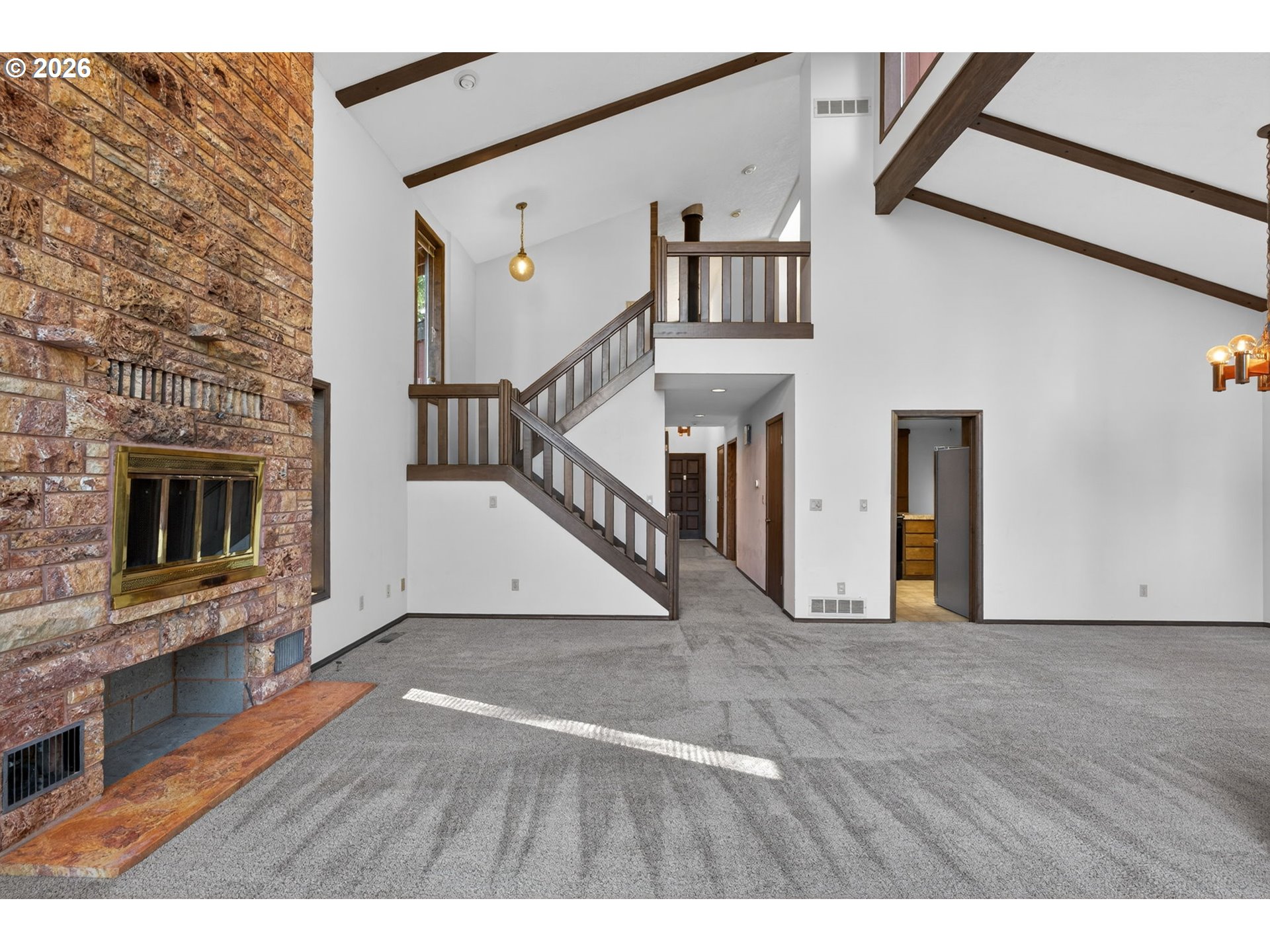 5205 Southwest 153rd Avenue Beaverton, OR 97007 - Photo 24 of 47 a view of an empty room with wooden floor and a fireplace