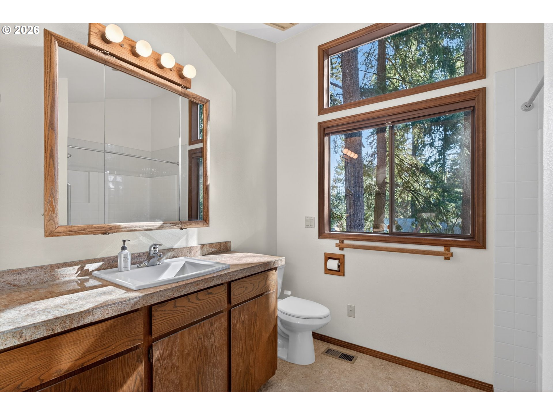 5205 Southwest 153rd Avenue Beaverton, OR 97007 - Photo 27 of 47 a bathroom with a granite countertop sink mirror and a large window