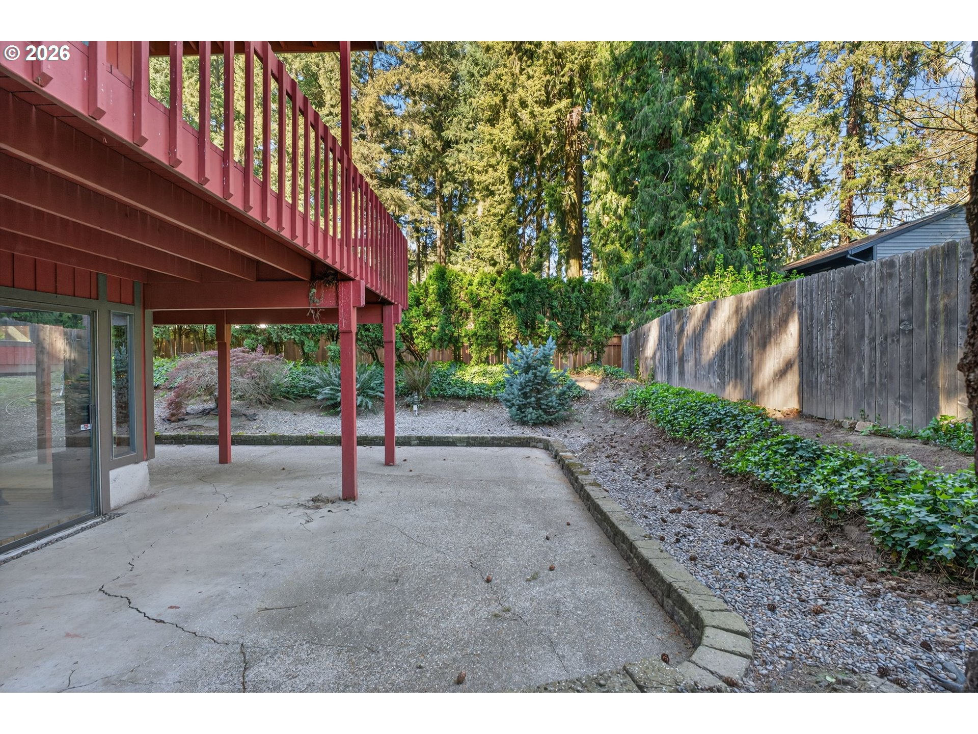 5205 Southwest 153rd Avenue Beaverton, OR 97007 - Photo 43 of 47 a view of a backyard with plants and wooden fence