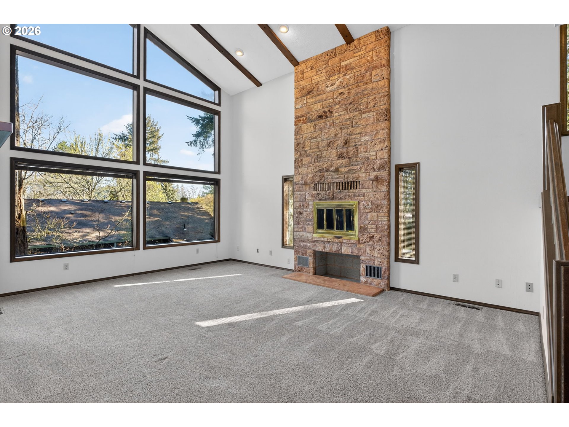 5205 Southwest 153rd Avenue Beaverton, OR 97007 - Photo 7 of 47 a view of an empty room with furniture and a fireplace