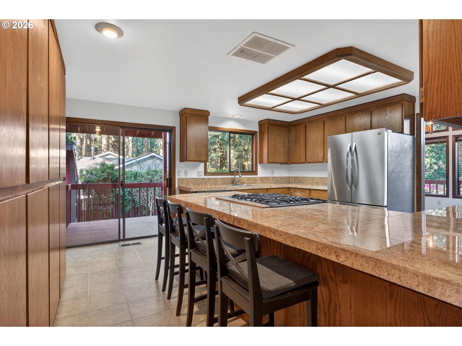 5205 Southwest 153rd Avenue Beaverton, OR 97007 - Photo 9 of 47 a kitchen with stainless steel appliances granite countertop a stove a sink and a refrigerator