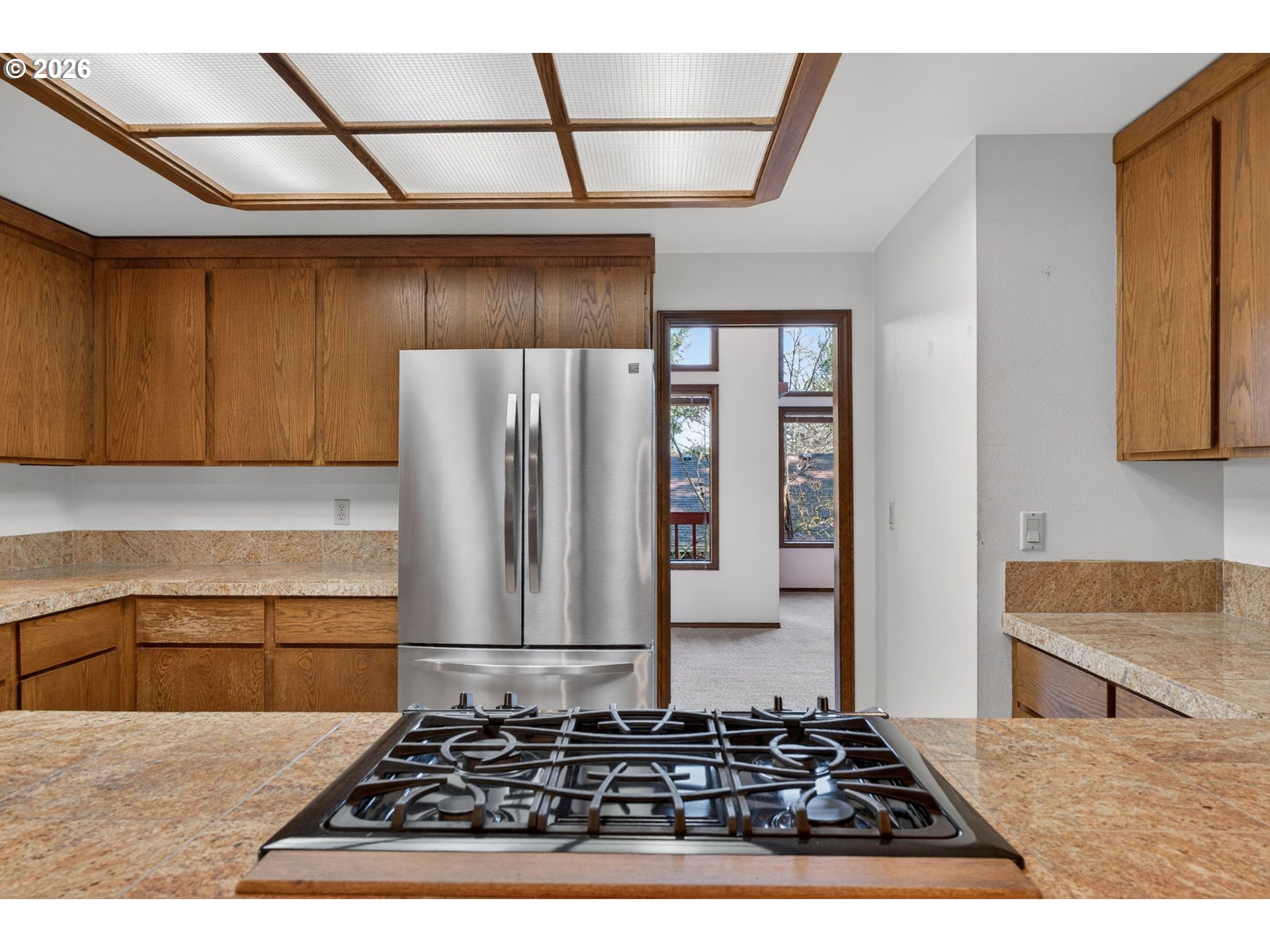 5205 Southwest 153rd Avenue Beaverton, OR 97007 - Photo 10 of 47 a kitchen with a stove a refrigerator and cabinets