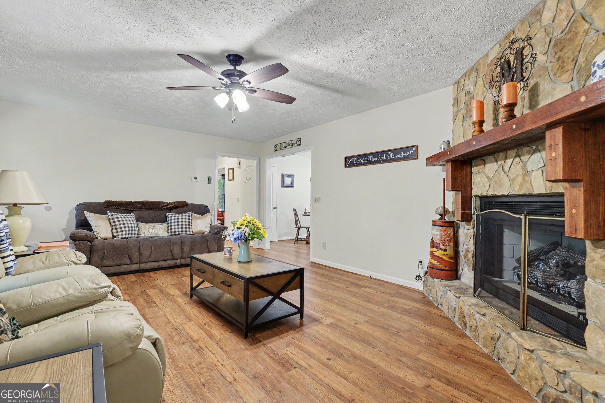 325 Walnut Mountain Road Rabun Gap, GA 30568 - Photo 12 of 38 a living room with furniture and a fireplace