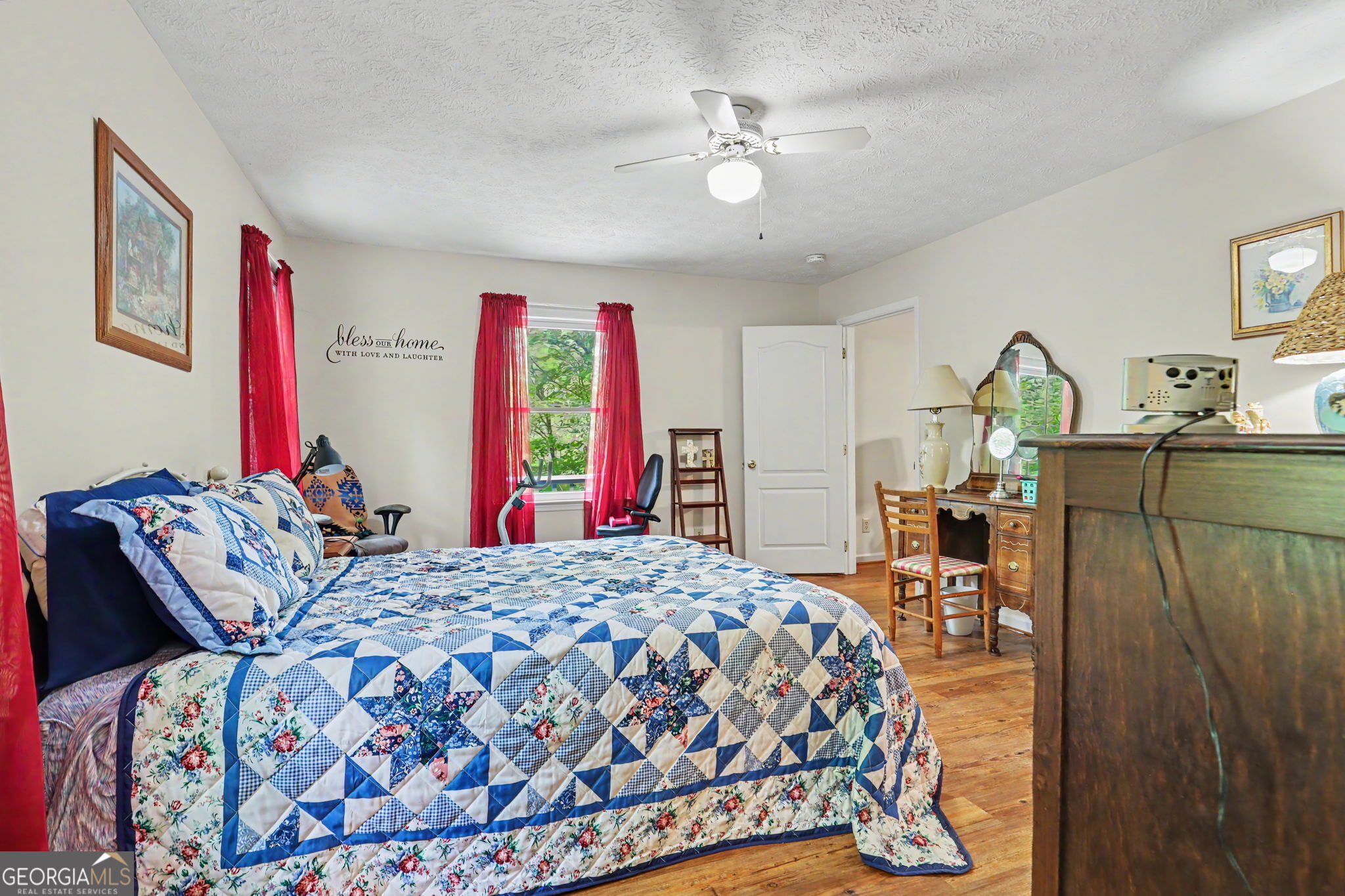 325 Walnut Mountain Road Rabun Gap, GA 30568 - Photo 16 of 38 a bedroom with a bed and a chandelier
