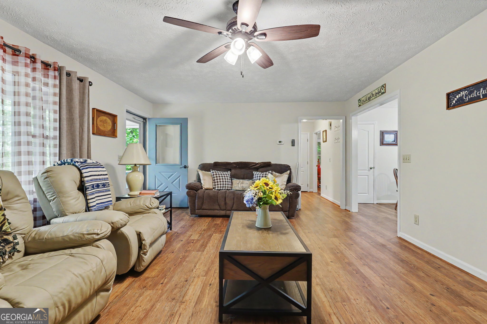 325 Walnut Mountain Road Rabun Gap, GA 30568 - Photo 17 of 38 a living room with furniture and a chandelier