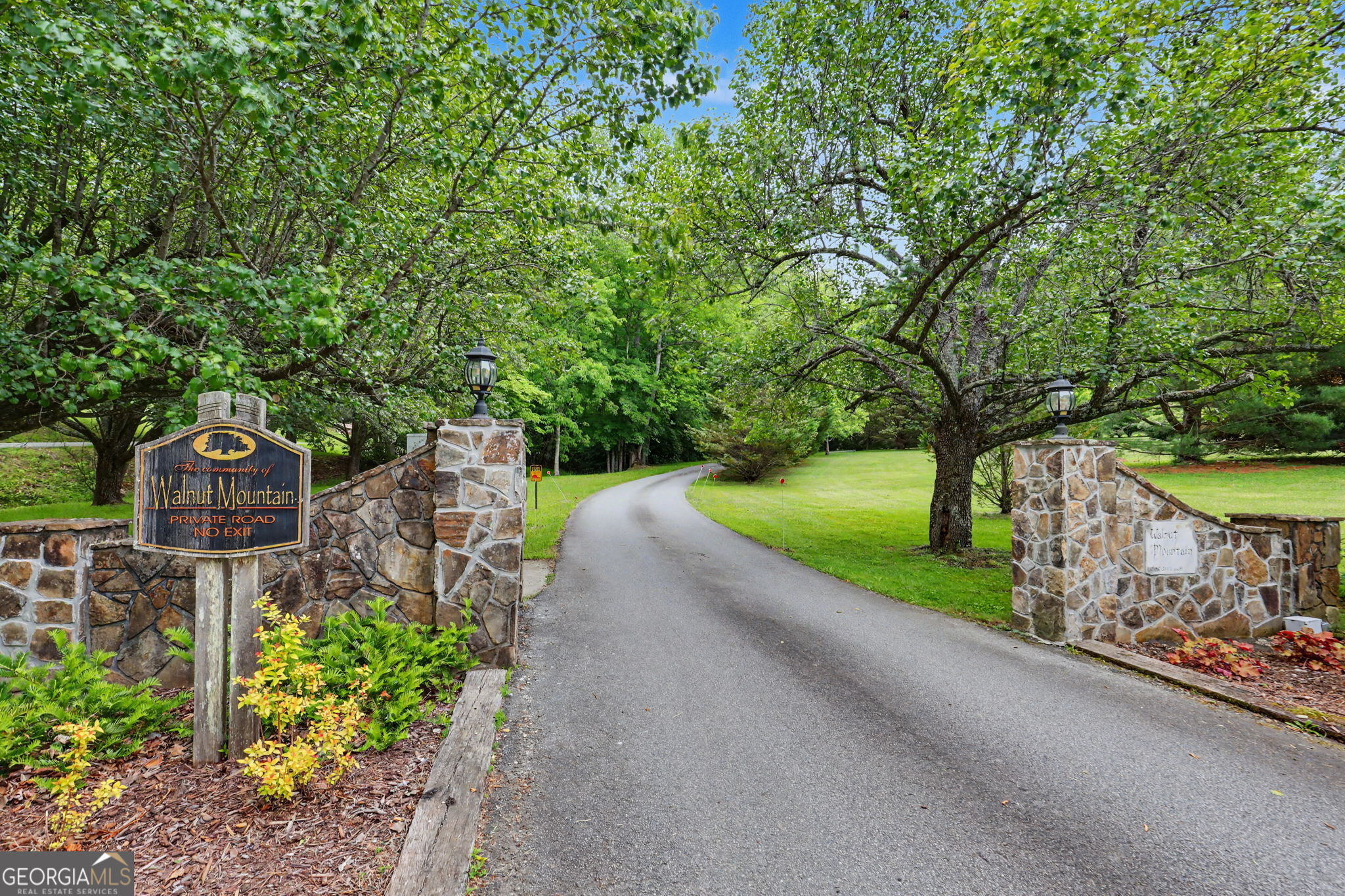 325 Walnut Mountain Road Rabun Gap, GA 30568 - Photo 2 of 38 a view of a street with a bench and trees around