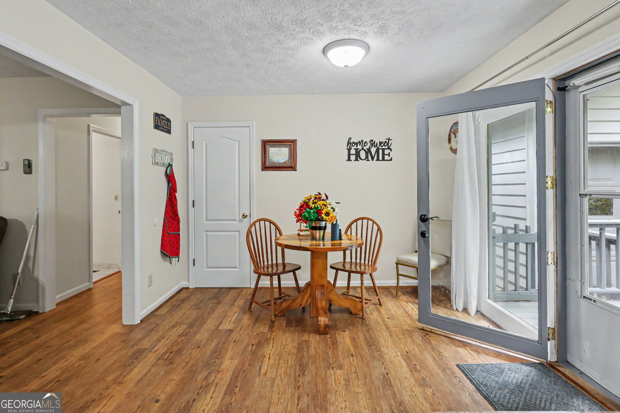 325 Walnut Mountain Road Rabun Gap, GA 30568 - Photo 23 of 38 a view of a dining room with furniture and wooden floor