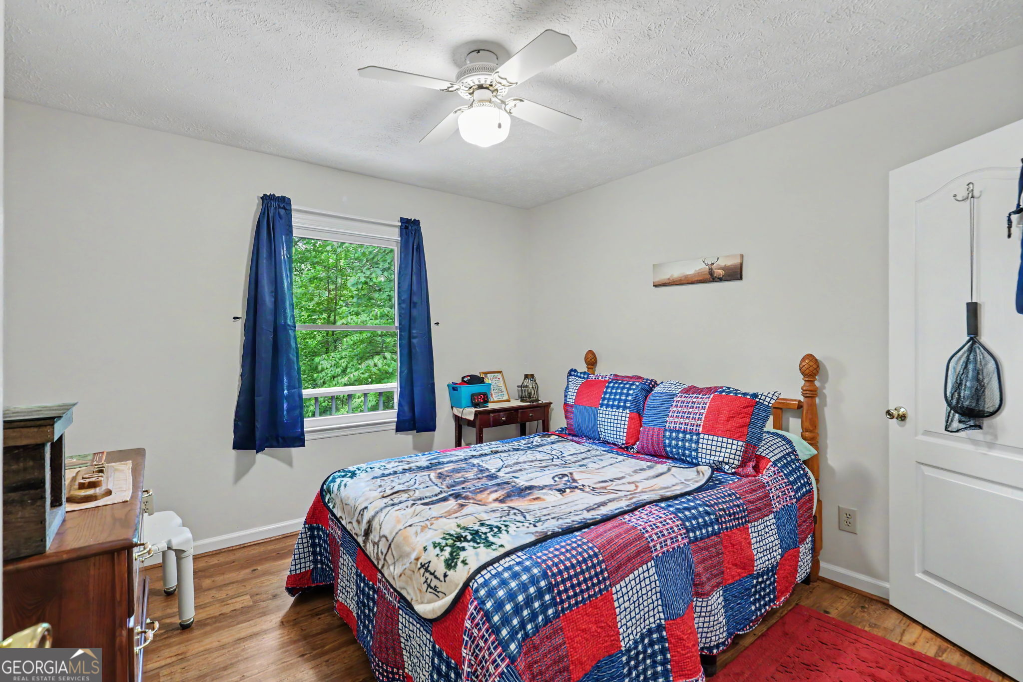 325 Walnut Mountain Road Rabun Gap, GA 30568 - Photo 25 of 38 a bed sitting in a bedroom next to a window