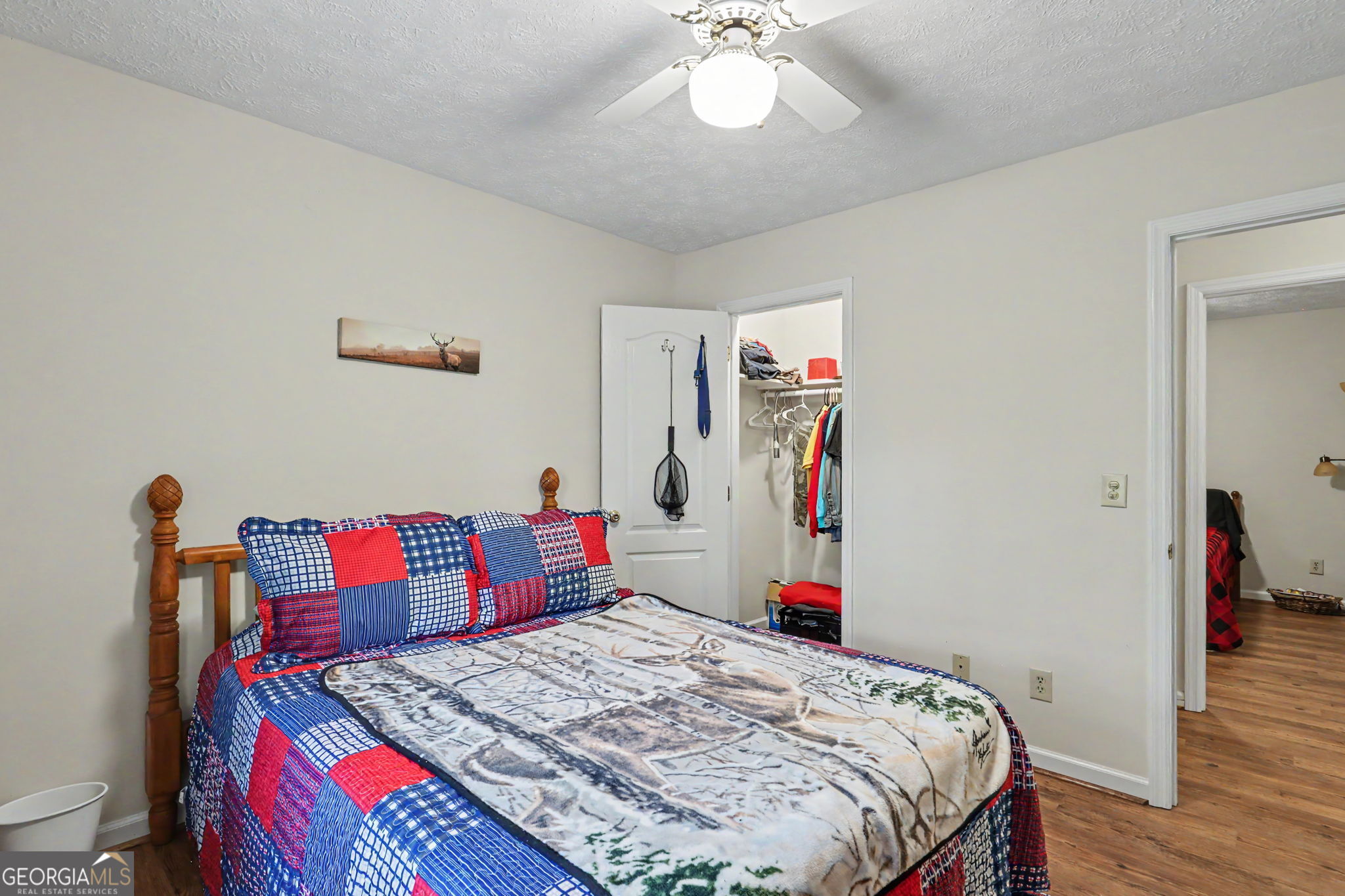 325 Walnut Mountain Road Rabun Gap, GA 30568 - Photo 26 of 38 a bedroom that has a bed and a chandelier