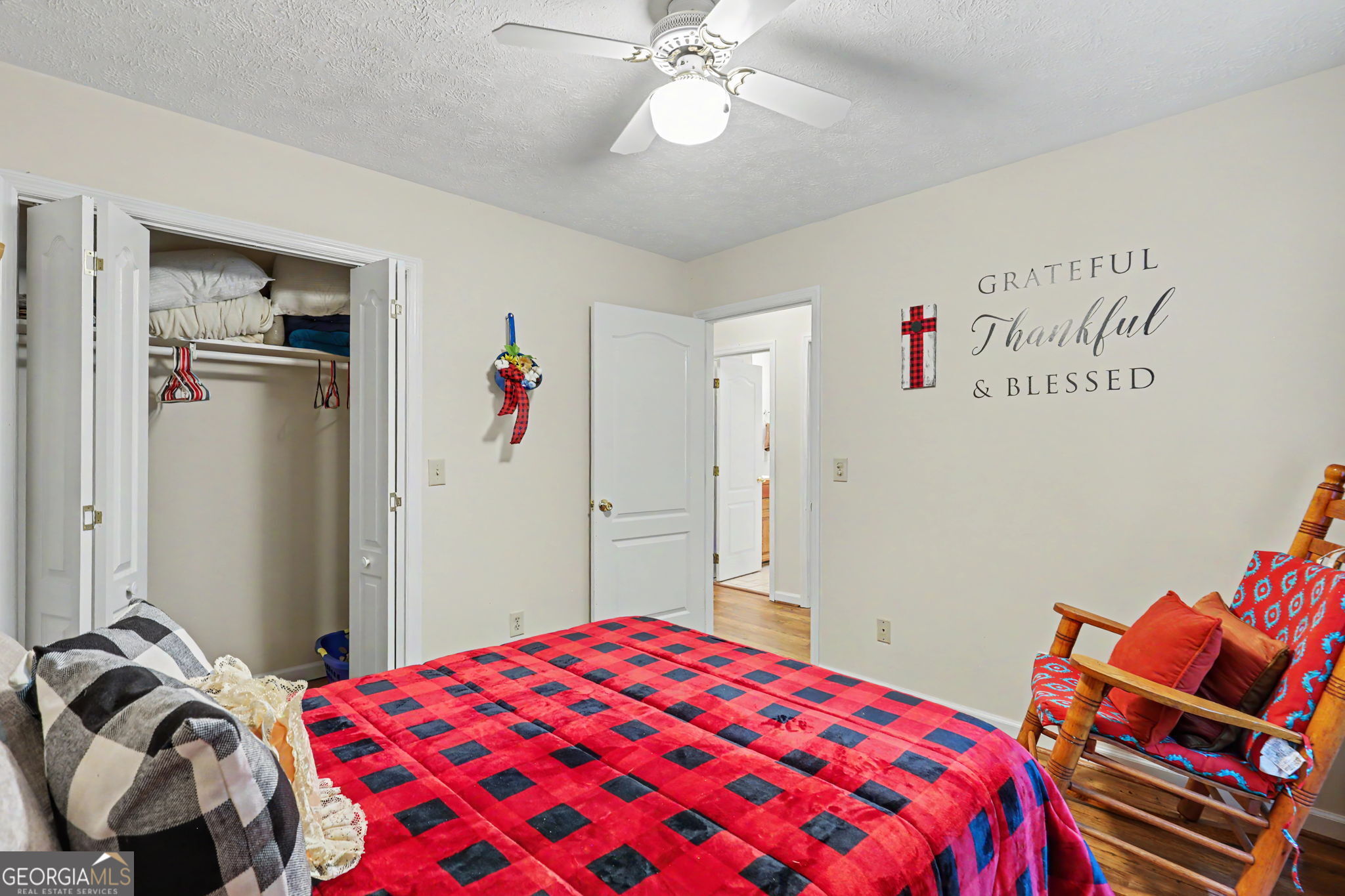 325 Walnut Mountain Road Rabun Gap, GA 30568 - Photo 28 of 38 a bedroom with a bed and a chandelier