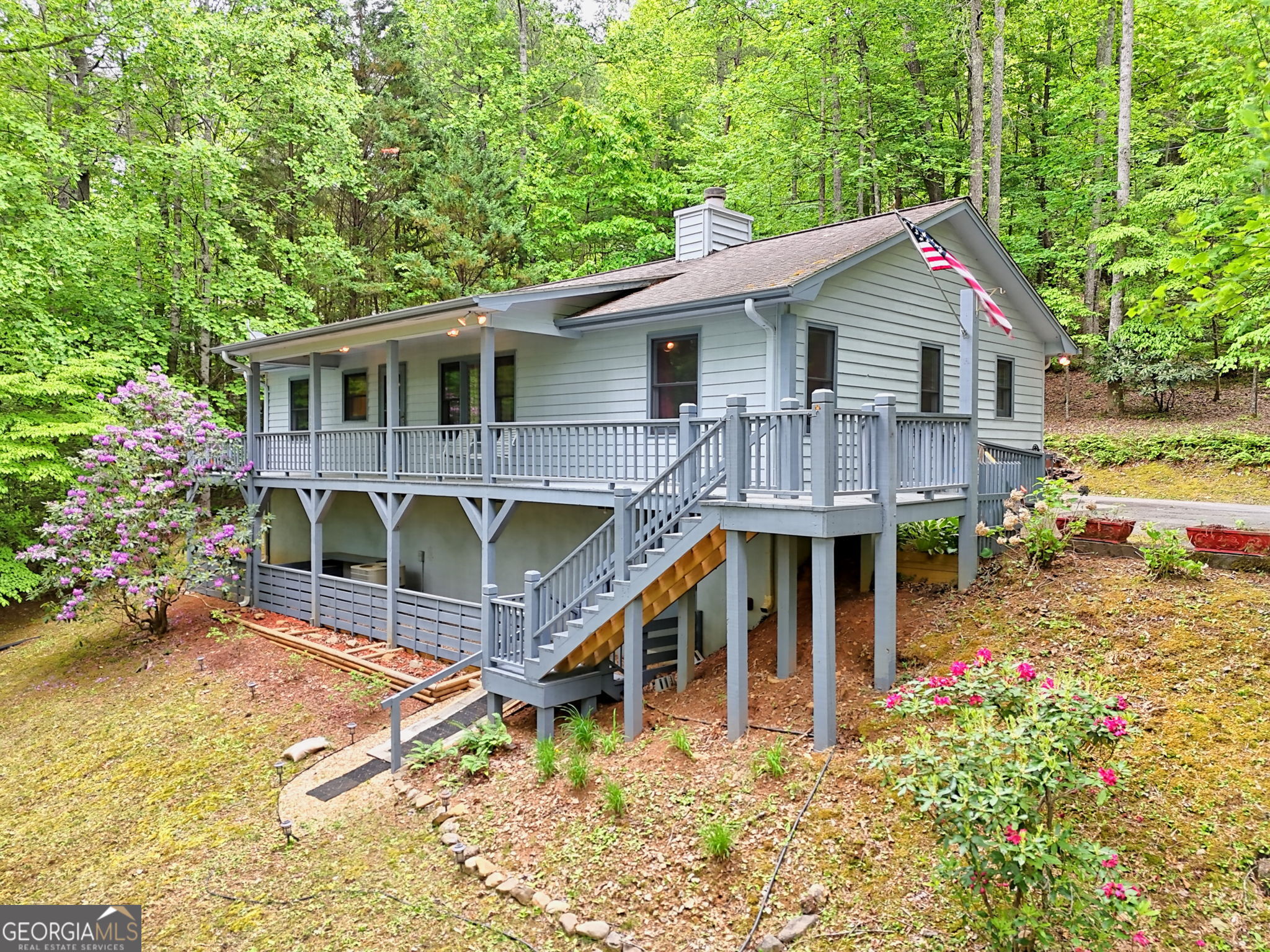 325 Walnut Mountain Road Rabun Gap, GA 30568 - Photo 3 of 38 a house view with a garden space
