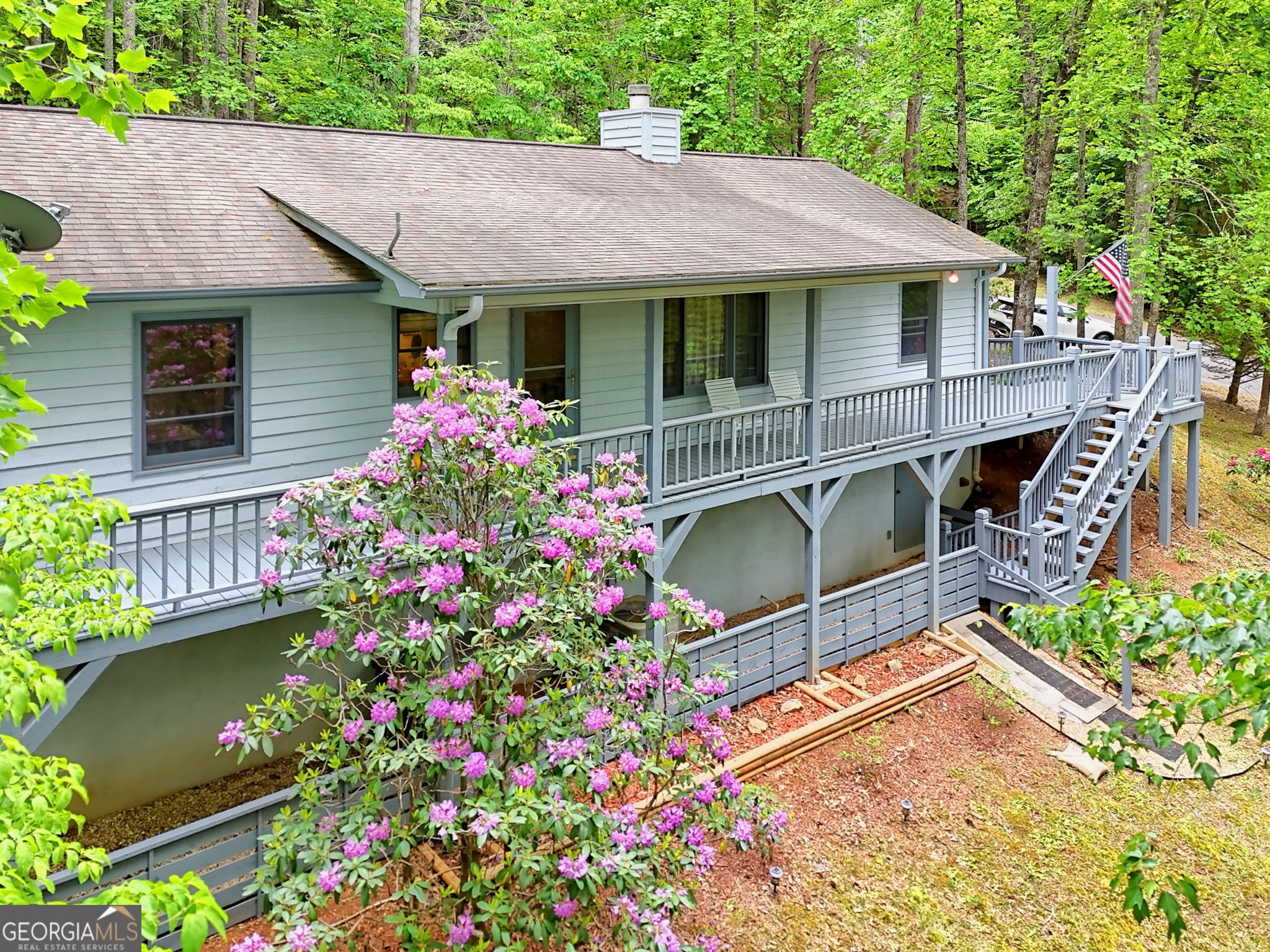 325 Walnut Mountain Road Rabun Gap, GA 30568 - Photo 34 of 38 a backyard of a house with a garden and outdoor seating
