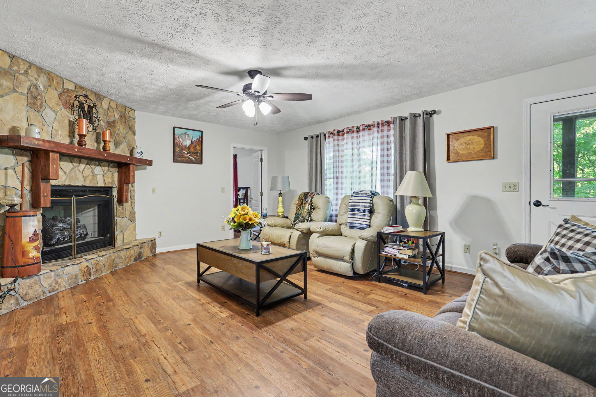 325 Walnut Mountain Road Rabun Gap, GA 30568 - Photo 10 of 38 a living room with furniture a fireplace and a window