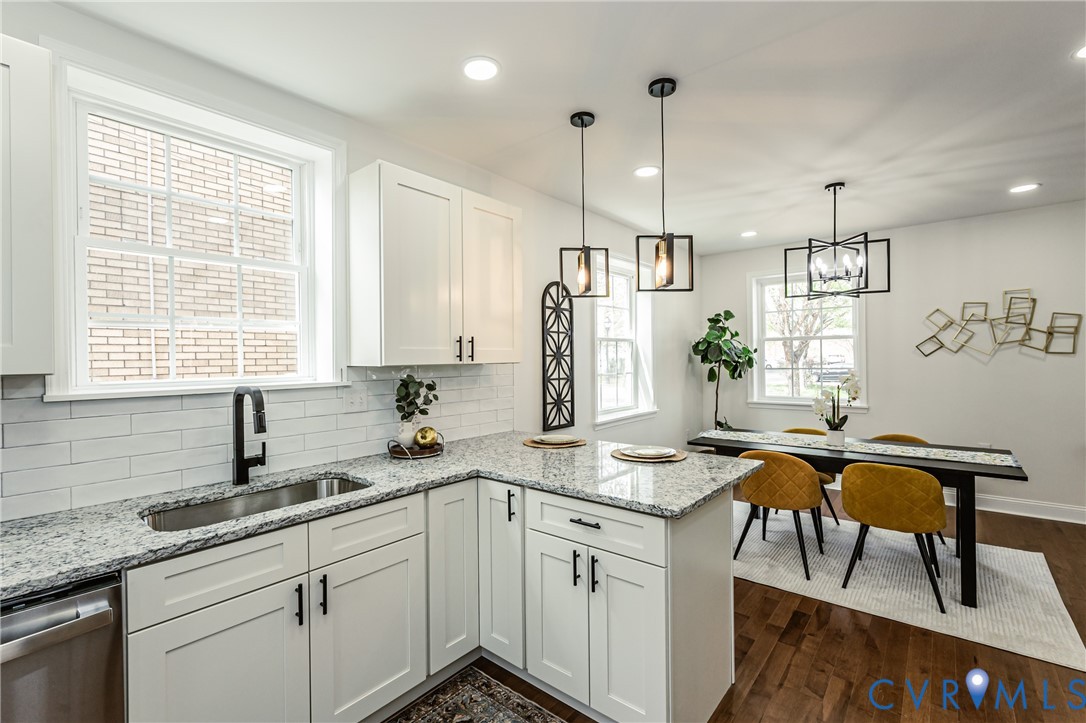 1400 Decatur Street Richmond, VA 23224 - Photo 21 of 49 a kitchen with stainless steel appliances granite countertop a sink a stove a dining table and chairs