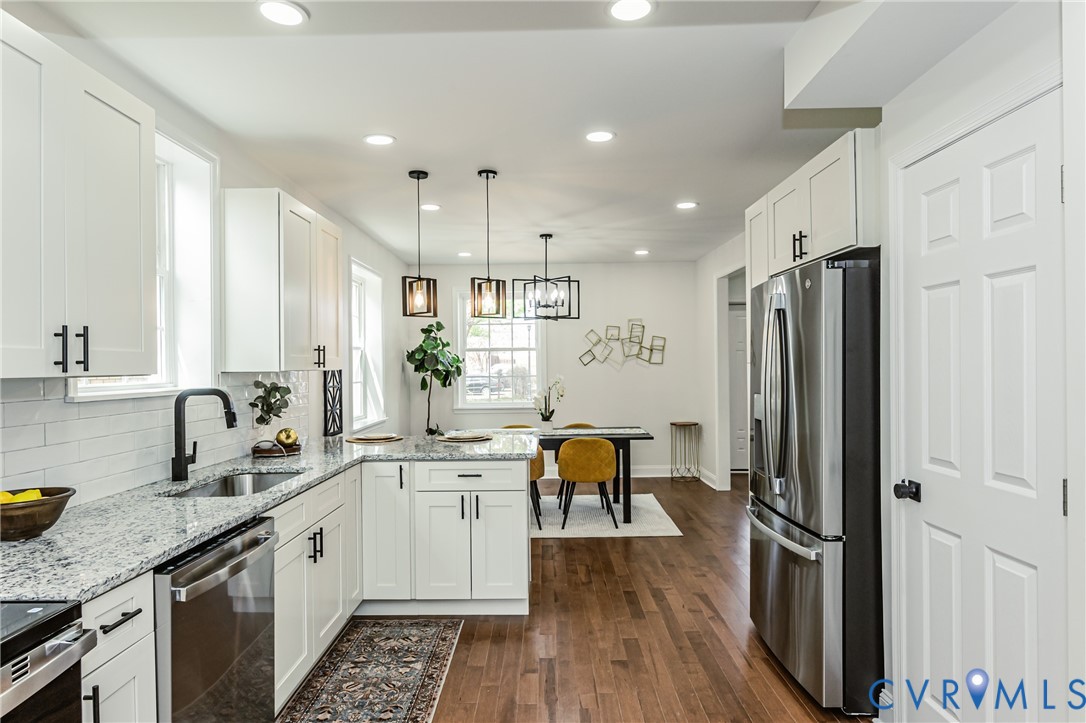 1400 Decatur Street Richmond, VA 23224 - Photo 23 of 49 a kitchen with stainless steel appliances granite countertop a refrigerator a sink dishwasher a stove and white cabinets with wooden floor