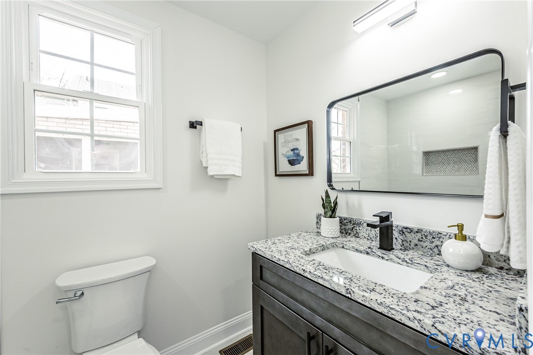 1400 Decatur Street Richmond, VA 23224 - Photo 27 of 49 a bathroom with a granite countertop sink and a mirror