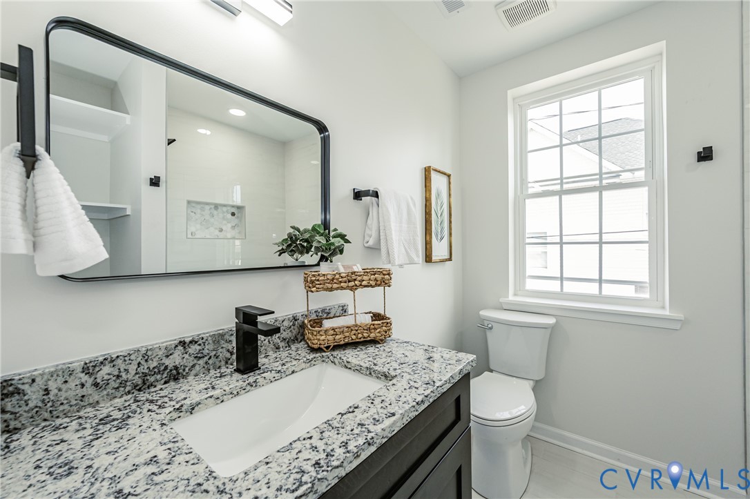1400 Decatur Street Richmond, VA 23224 - Photo 39 of 49 a bathroom with a granite countertop sink a toilet and a mirror
