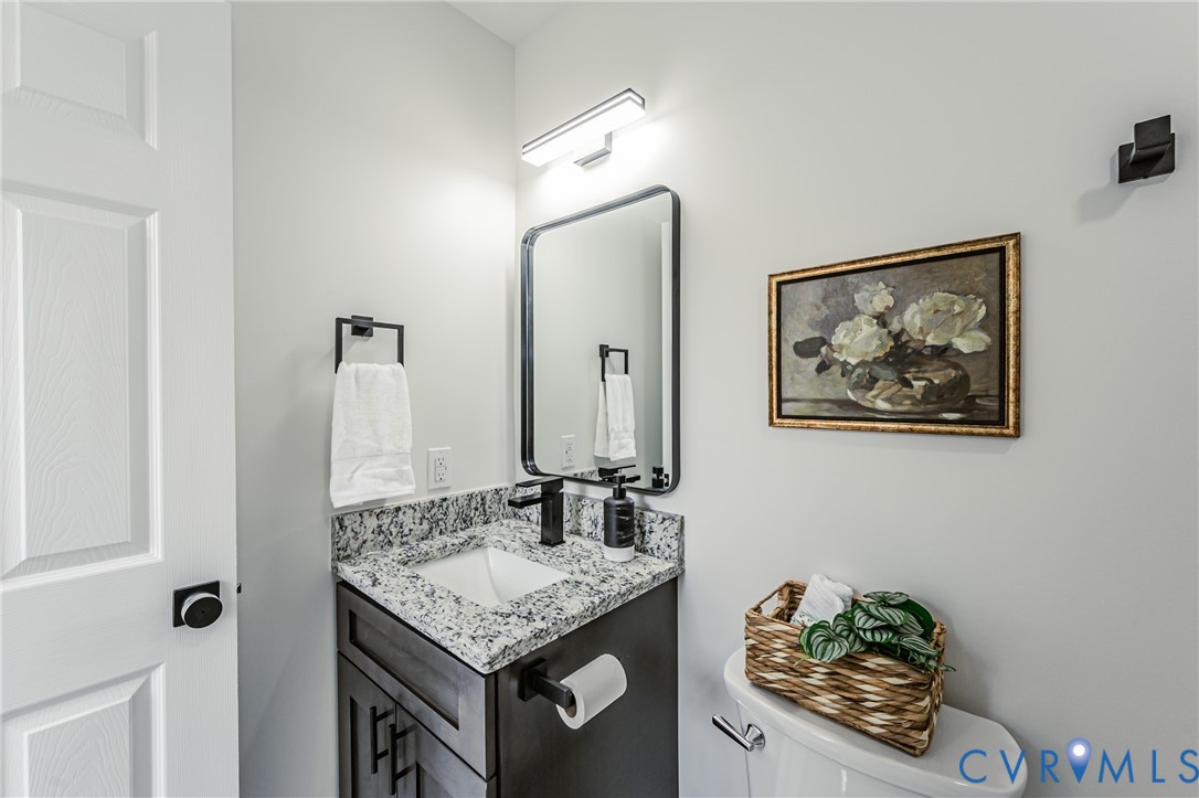 1400 Decatur Street Richmond, VA 23224 - Photo 46 of 49 a bathroom with a granite countertop sink and a mirror