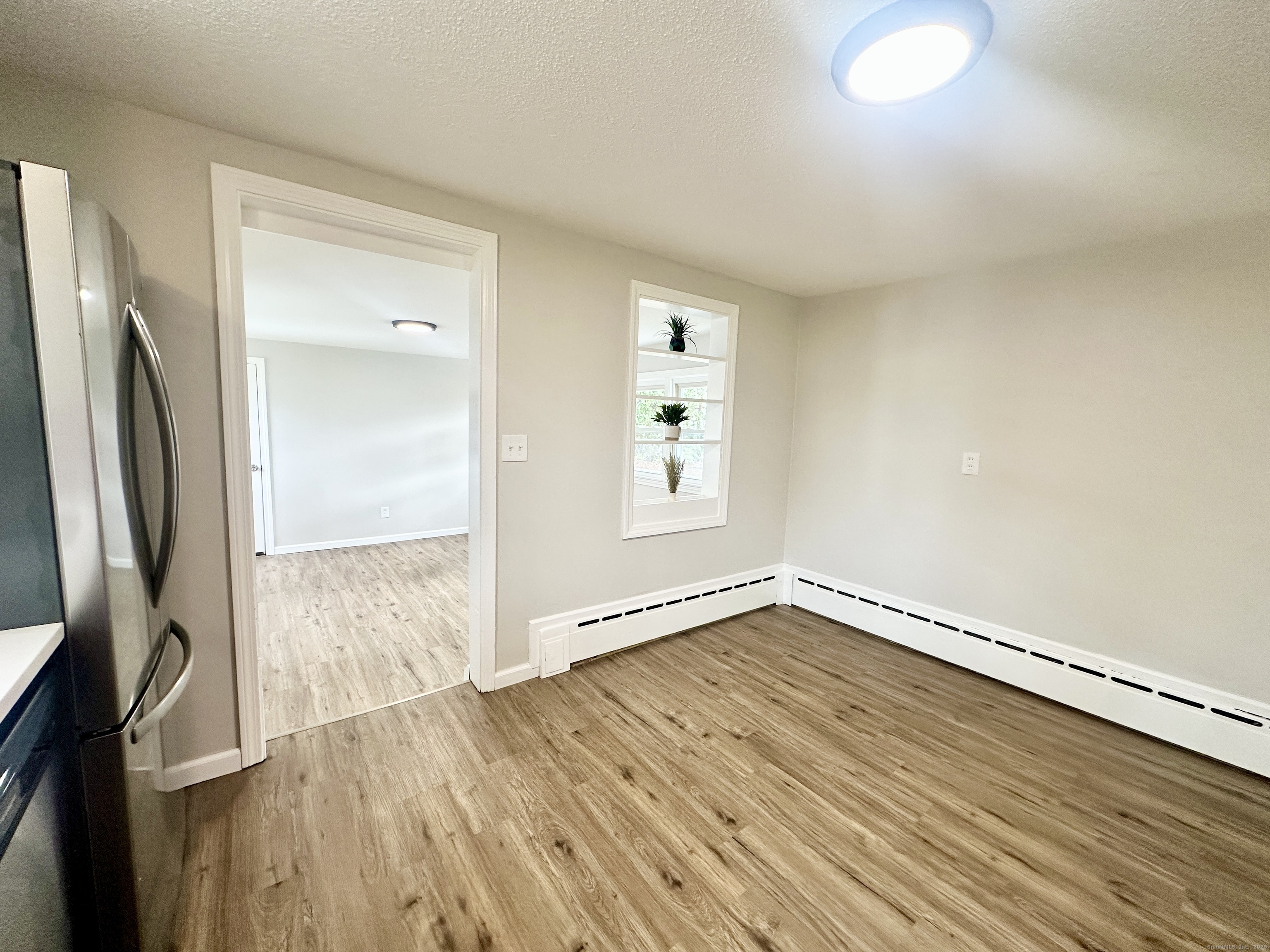 9 Eleanor Road Enfield, CT 06082 - Photo 13 of 32 a view of an empty room with wooden floor and a window