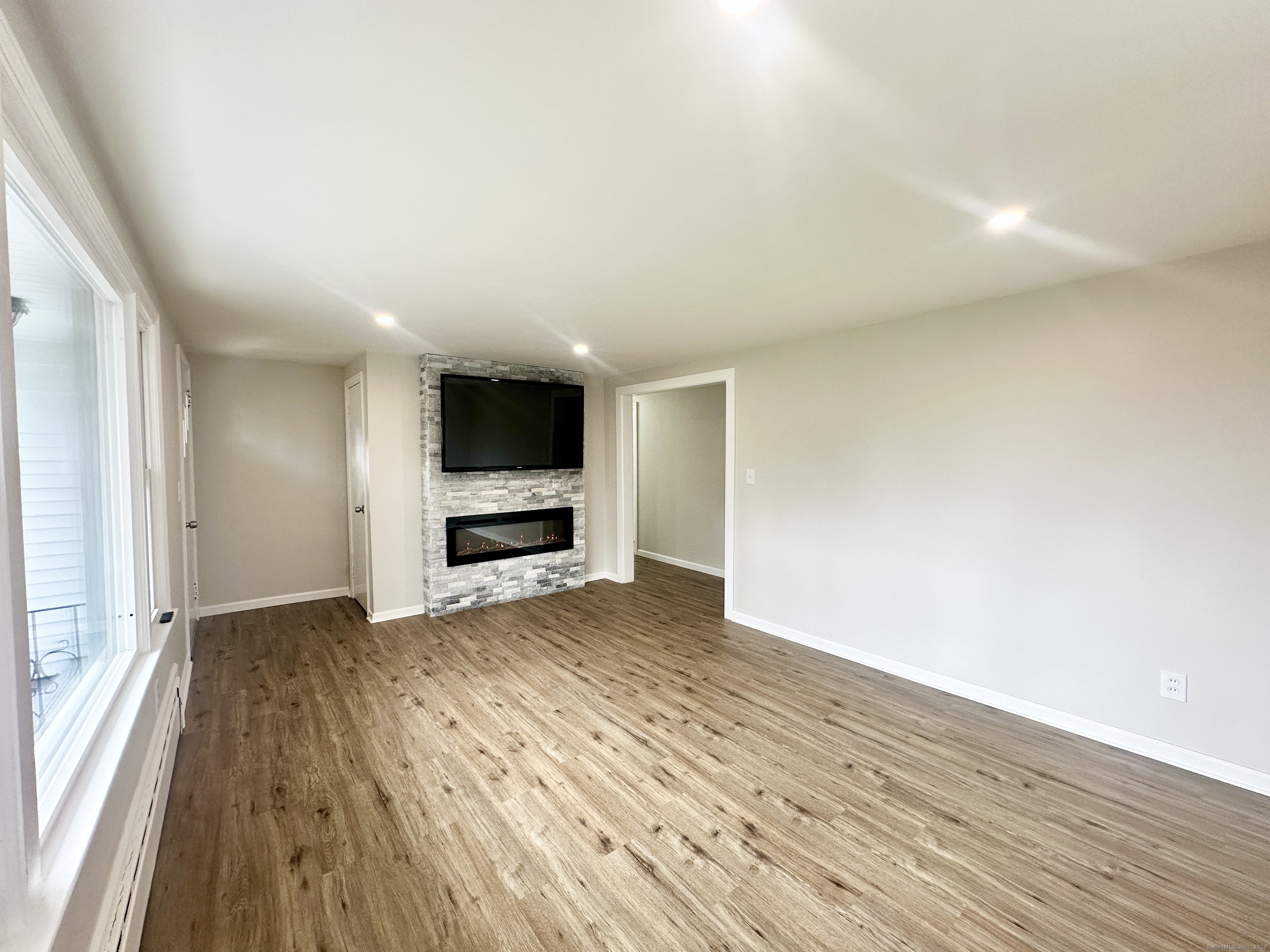 9 Eleanor Road Enfield, CT 06082 - Photo 15 of 32 a view of an empty room with wooden floor and a window