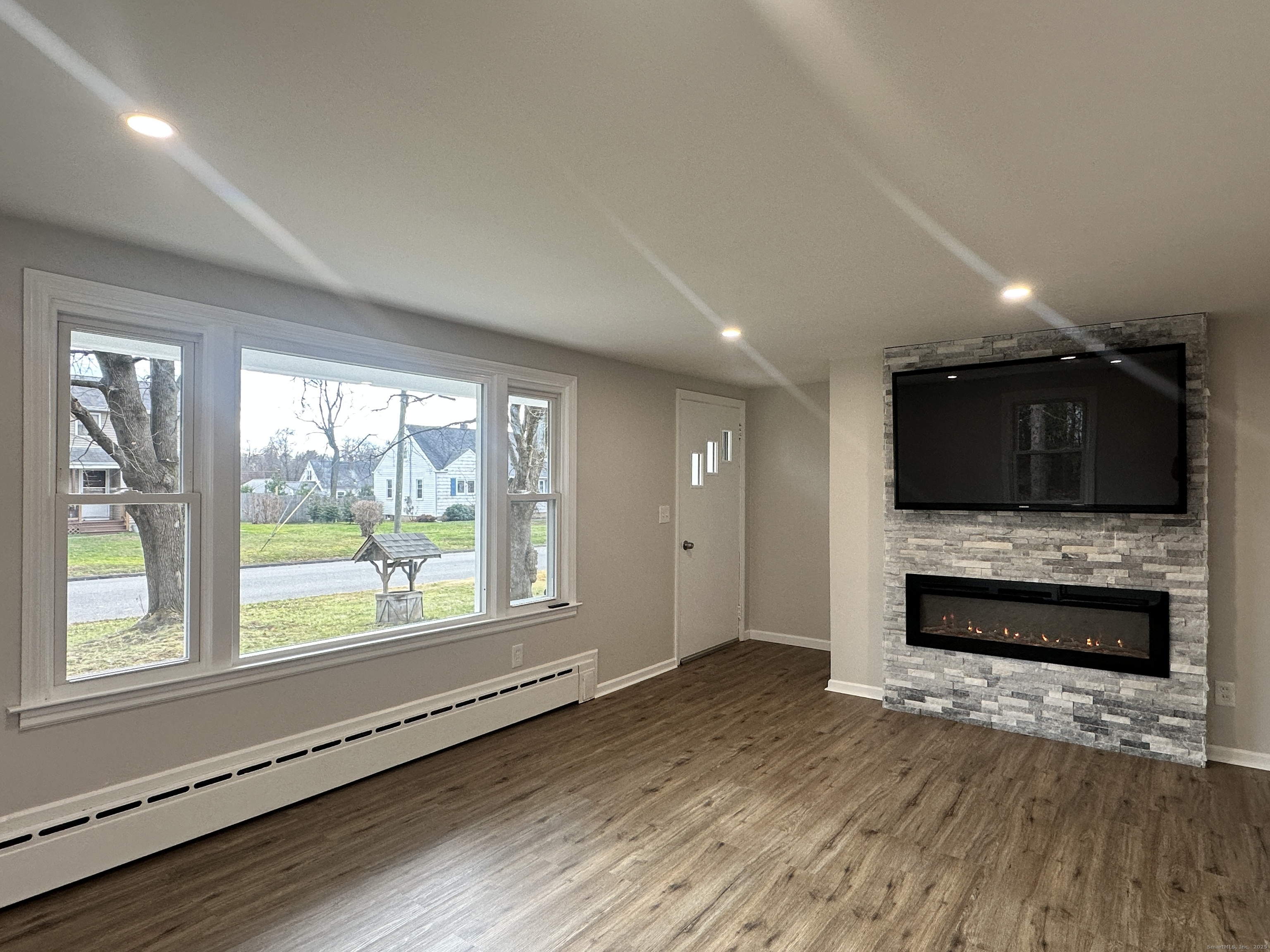9 Eleanor Road Enfield, CT 06082 - Photo 18 of 32 wooden floor in an empty room with a fireplace