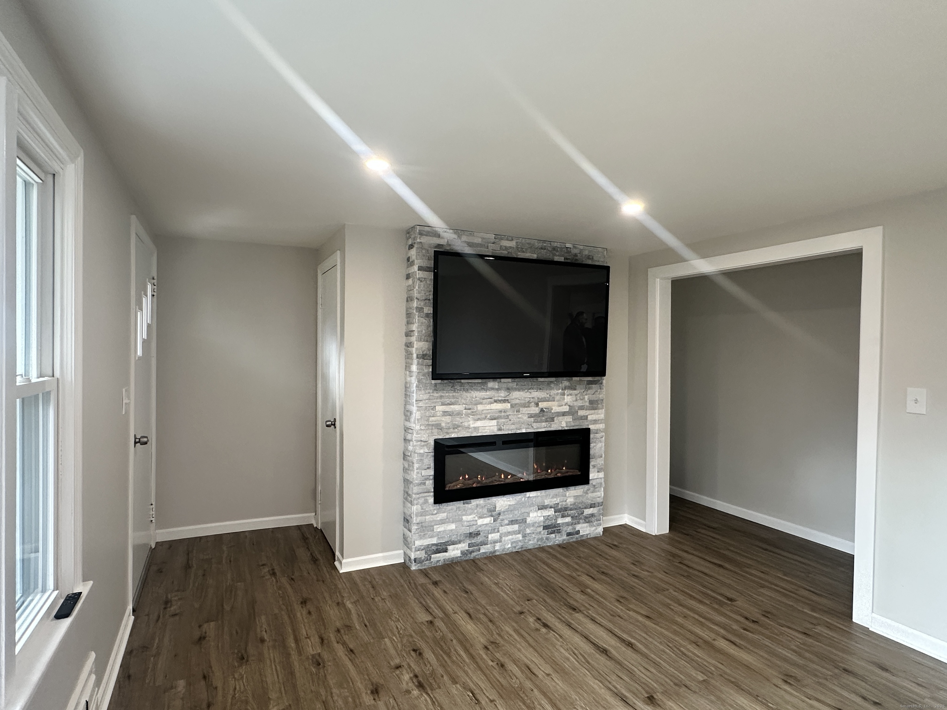 9 Eleanor Road Enfield, CT 06082 - Photo 19 of 32 a view of empty room with wooden floor and fireplace