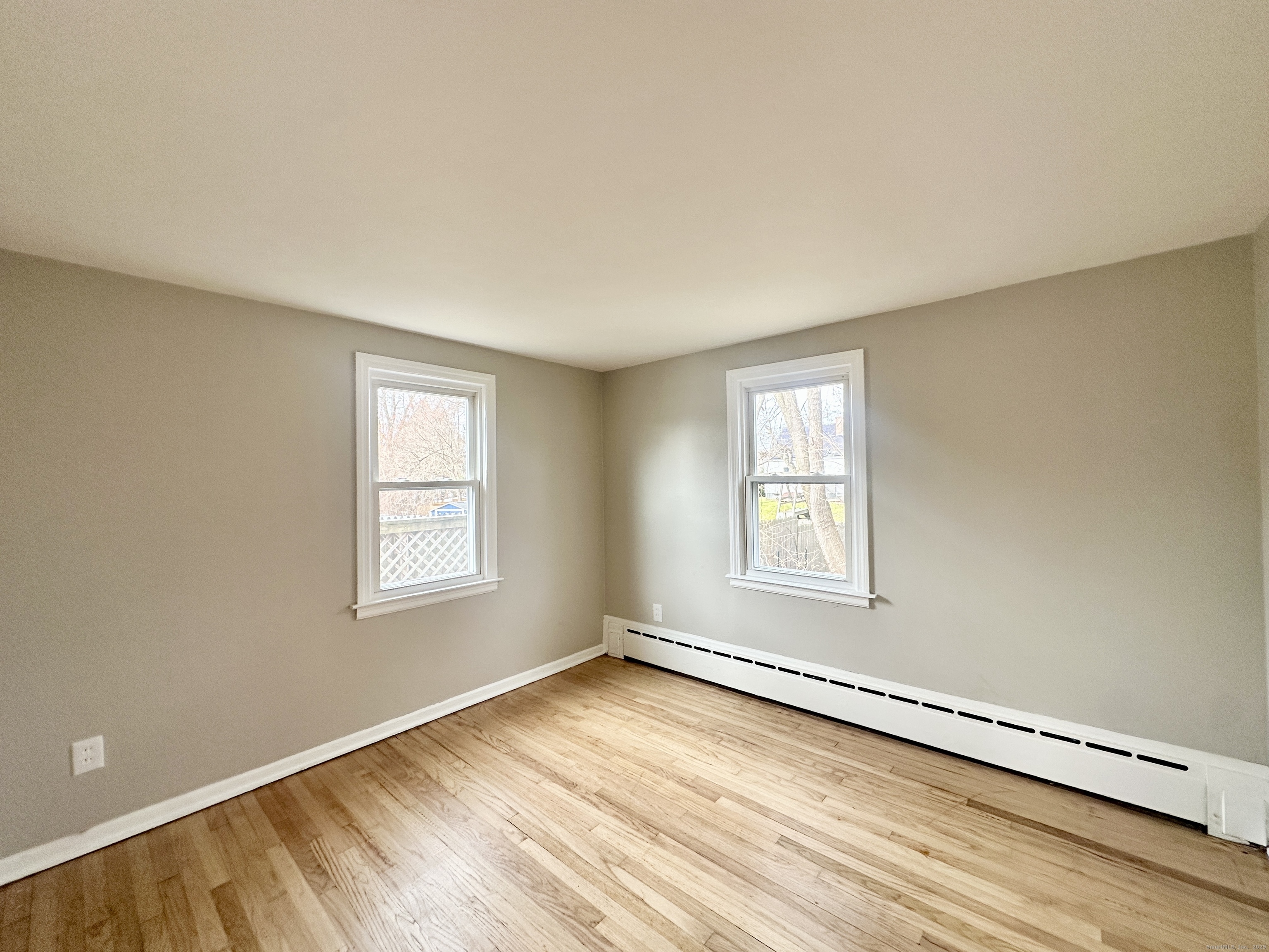 9 Eleanor Road Enfield, CT 06082 - Photo 23 of 32 a view of an empty room with wooden floor and a window