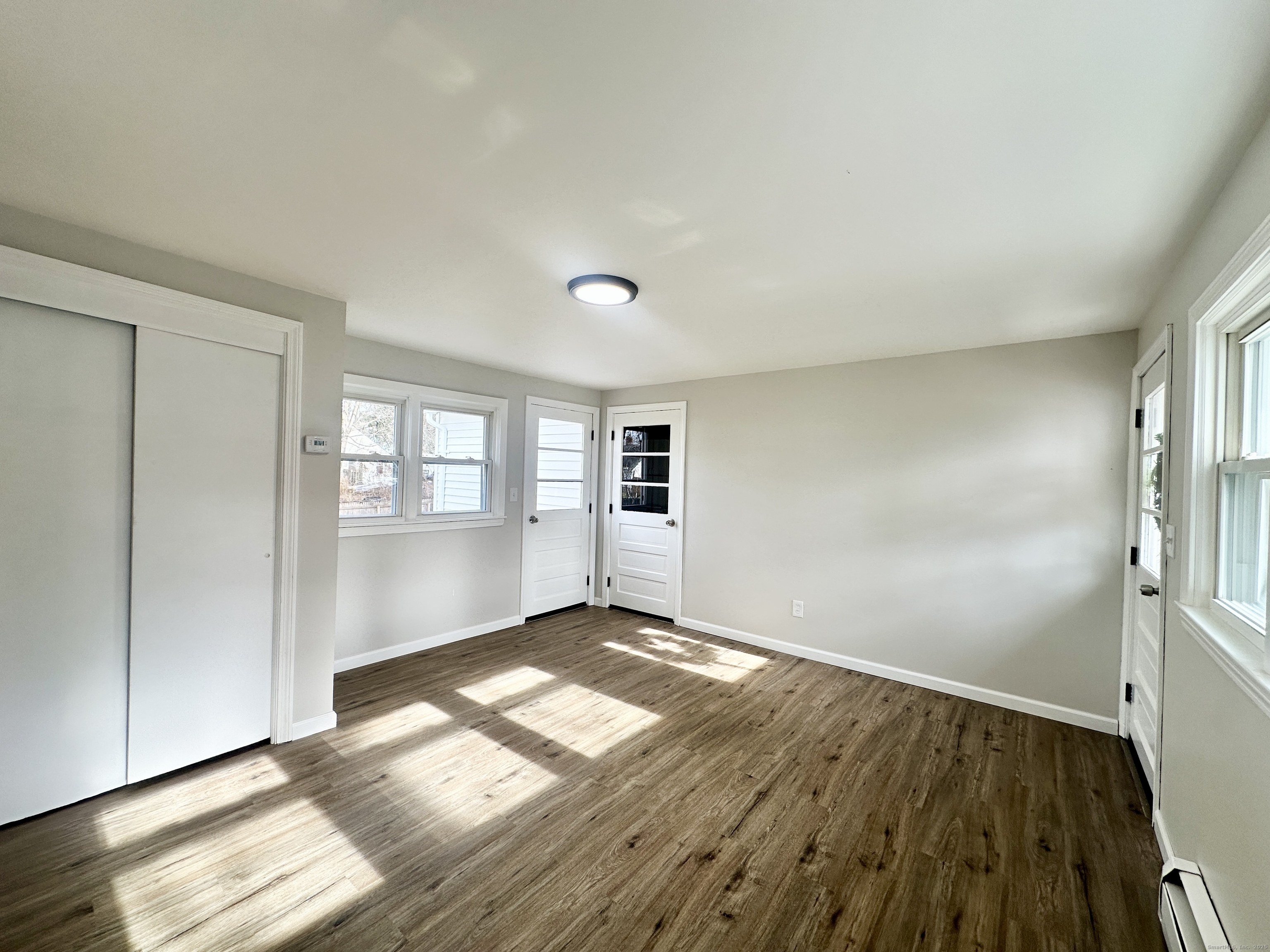 9 Eleanor Road Enfield, CT 06082 - Photo 7 of 32 an empty room with wooden floor and windows