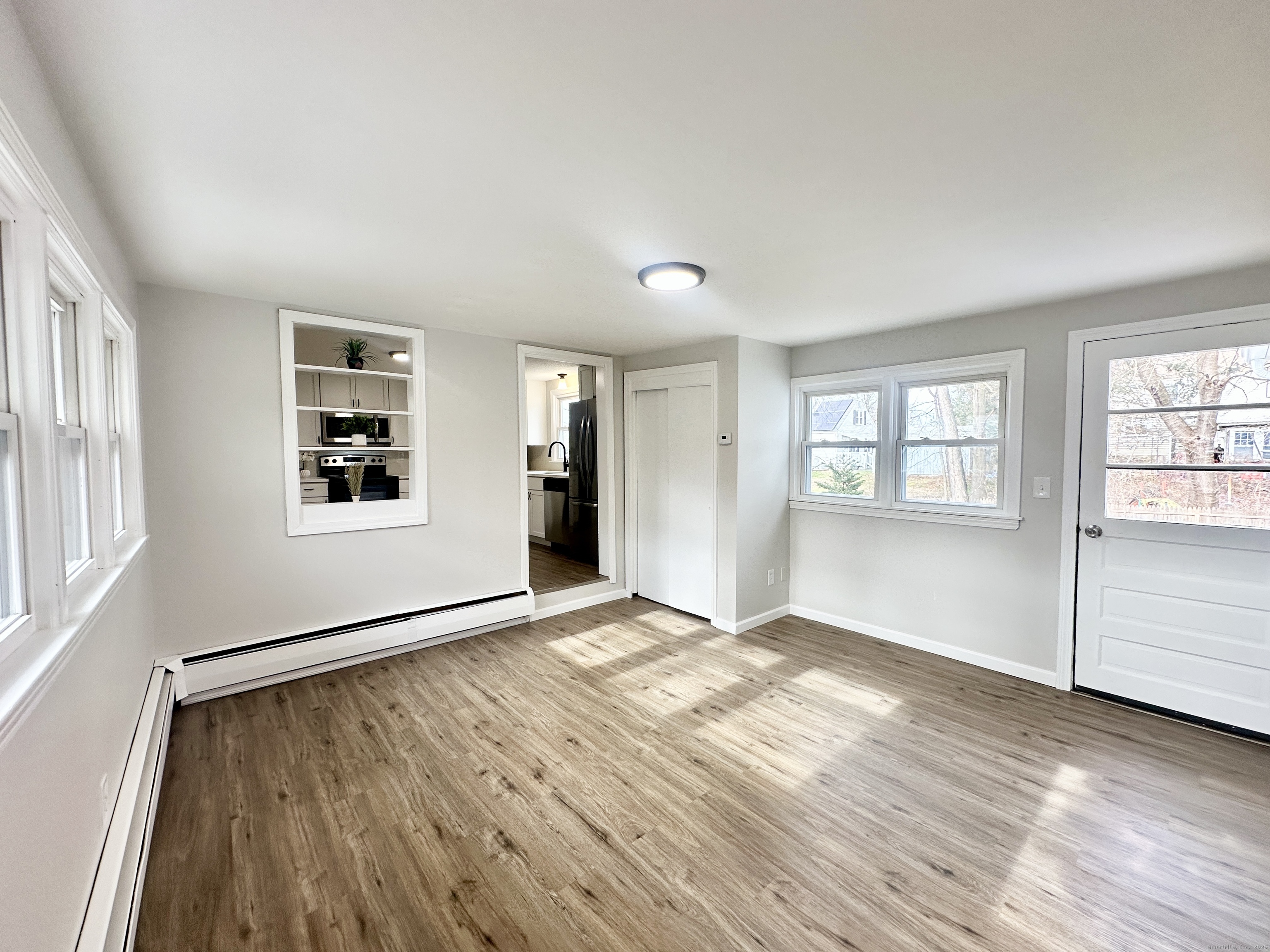 9 Eleanor Road Enfield, CT 06082 - Photo 9 of 32 an empty room with wooden floor and windows