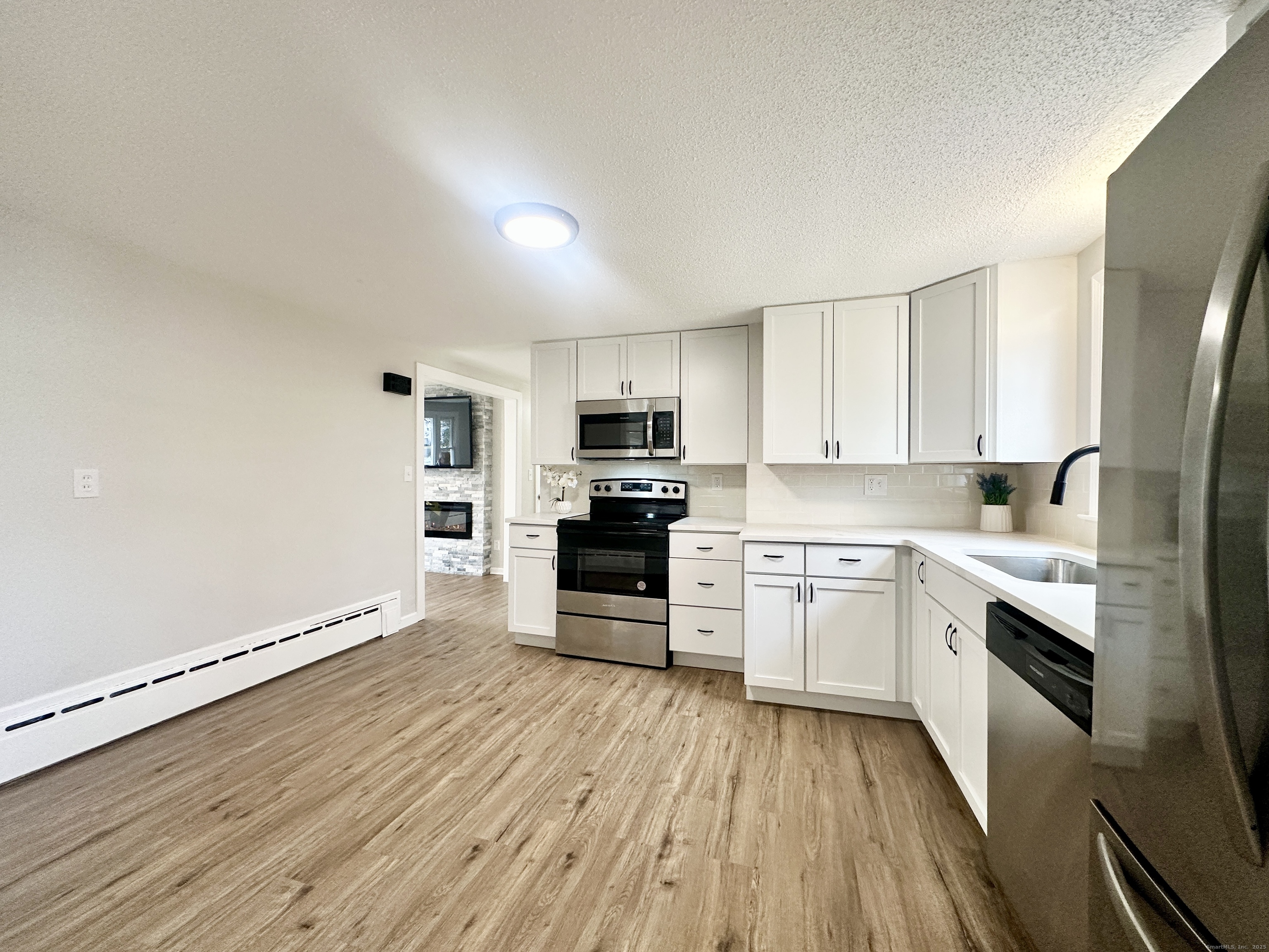 9 Eleanor Road Enfield, CT 06082 - Photo 10 of 32 a kitchen with granite countertop a refrigerator stove top oven and sink