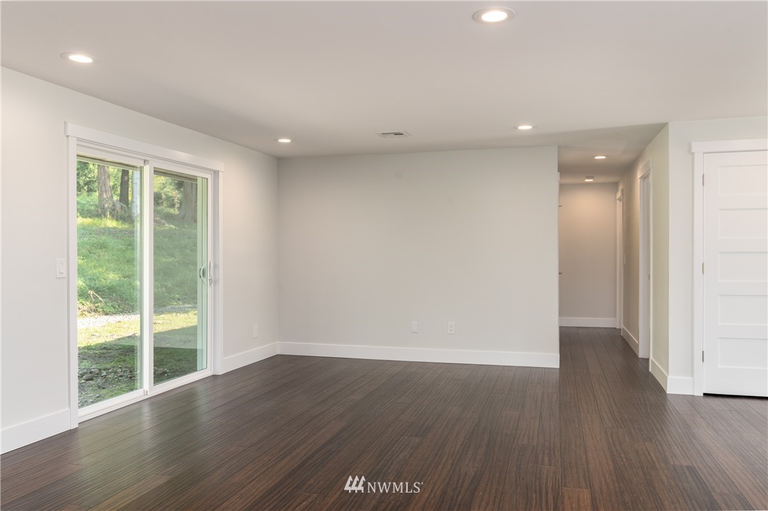14425 Westwick Road Snohomish, WA 98290 - Photo 12 of 25 a view of an empty room with wooden floor and a window