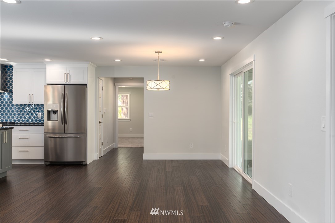 14425 Westwick Road Snohomish, WA 98290 - Photo 13 of 25 a view of kitchen with refrigerator and wooden floor