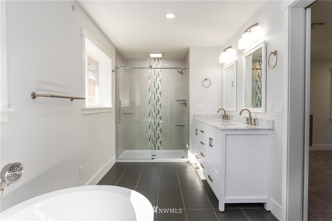 14425 Westwick Road Snohomish, WA 98290 - Photo 18 of 25 a bathroom with a sink a toilet and shower