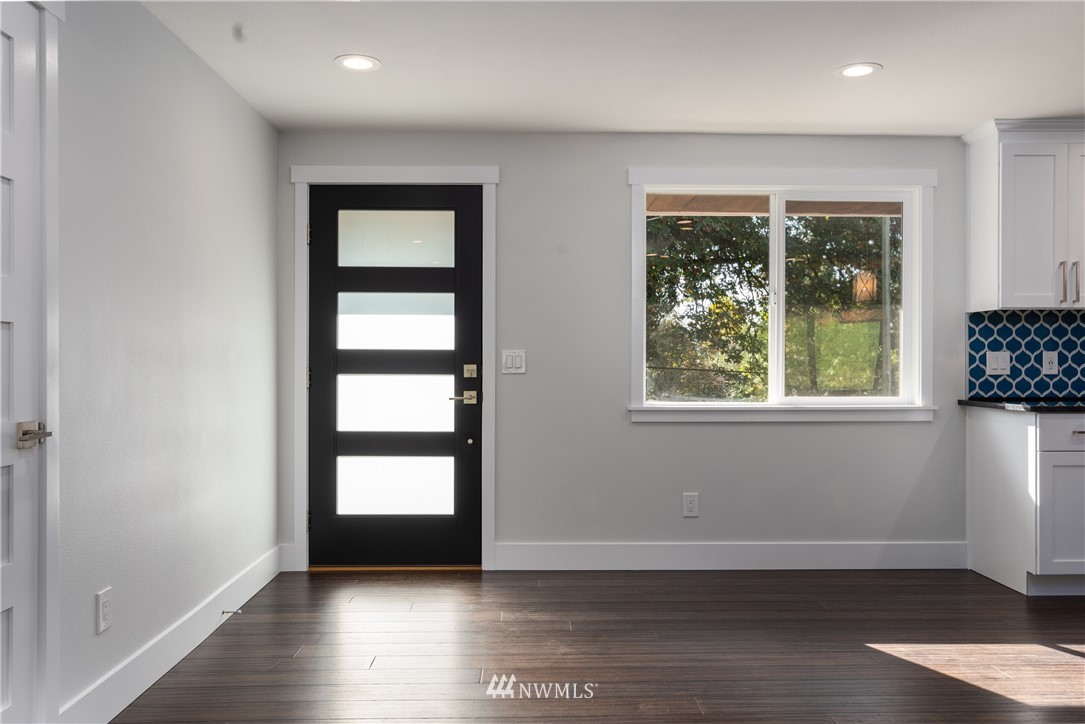 14425 Westwick Road Snohomish, WA 98290 - Photo 5 of 25 an empty room with wooden floor and windows