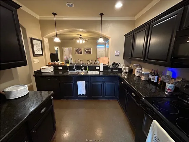 a kitchen with a sink stove and cabinets