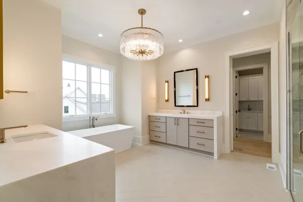 a spacious bathroom with a granite countertop sink a toilet a mirror and shower