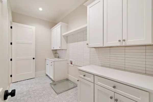 a kitchen with a sink and cabinets