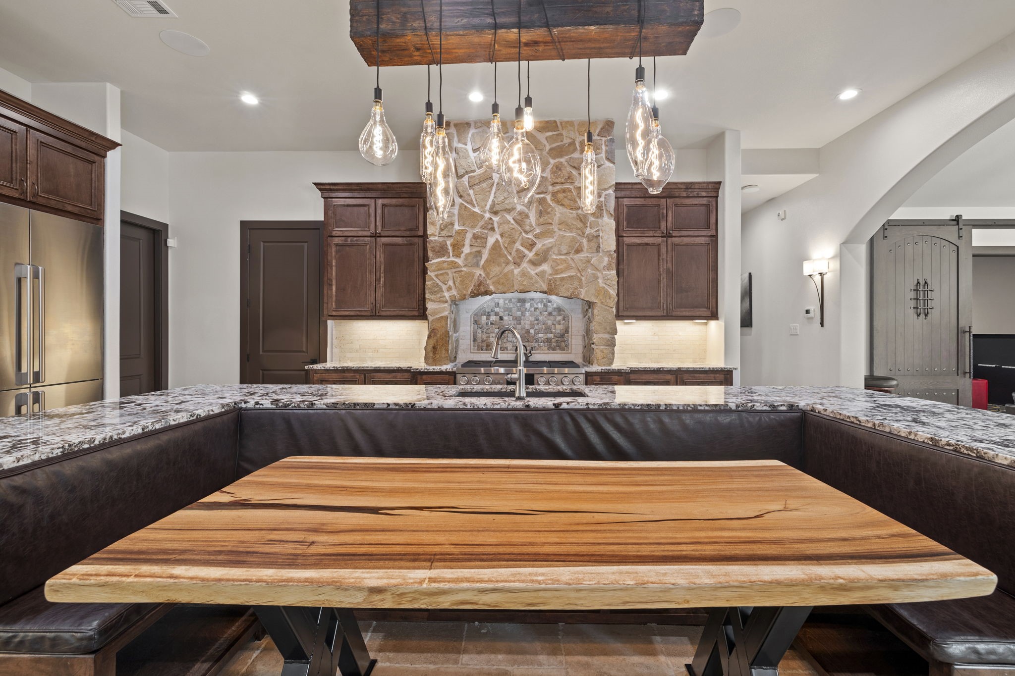 4322 Maple Rapids Court Spring, TX 77386 - Photo 17 of 48 Built in island seating accenting stonework with large gas cooktop.